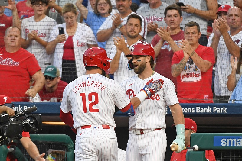 Sep 10, 2024; Philadelphia, Pennsylvania, USA; Philadelphia Phillies designated hitter Kyle Schwarber (12) celebrates his home run with first base Bryce Harper (3) during the first inning against the Tampa Bay Rays at Citizens Bank Park. Mandatory Credit: Eric Hartline-Imagn Images