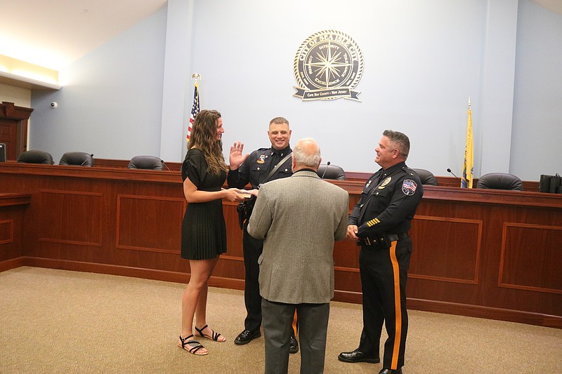 With his wife, Sarah, holding the Bible, Lt. Shawn Lesniewski is sworn in by Mayor Leonard Desiderio and Police Chief Anthony Garreffi.