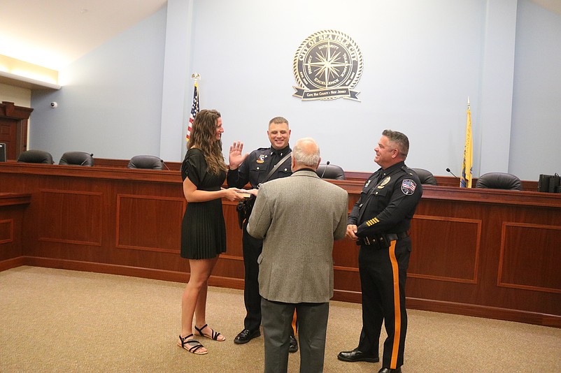 With his wife, Sarah, holding the Bible, Lt. Shawn Lesniewski is sworn in by Mayor Leonard Desiderio and Police Chief Anthony Garreffi.