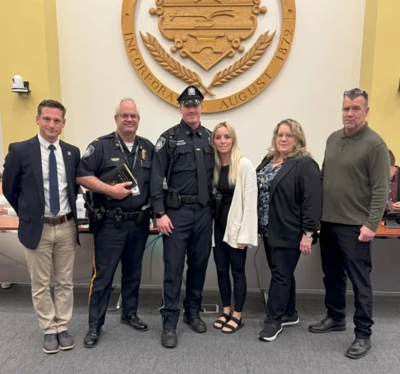 New Lansdale police Officer Daniel Talbot, center, poses alongside Mayor Garry Herbert, police Chief Mike Trail and his family after being sworn in during the May 21, 2025 borough council meeting. (Credit: Lansdale Police Department)