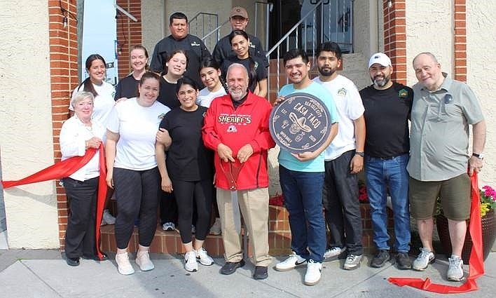 Mayor Leonard Desiderio, center, joins with Casa Taco's owners, employees and supporters to celebrate the restaurant's new location. (Photo courtesy of Sea Isle City)