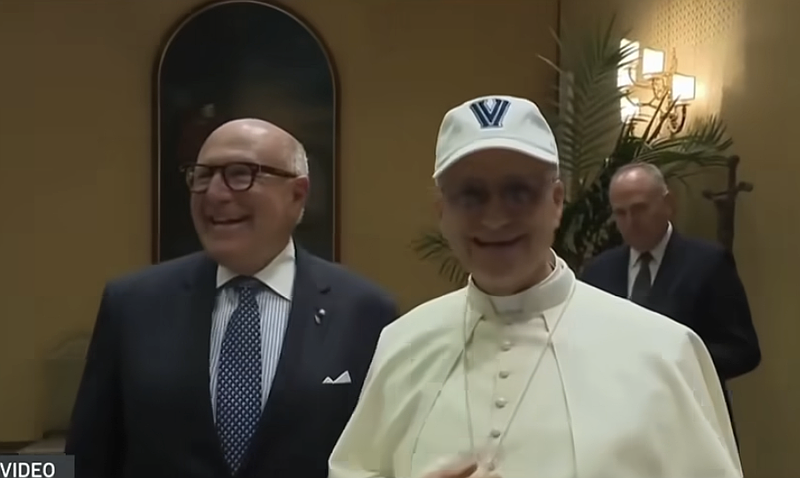 Pope Leo XIV puts on a Villanova baseball cap in support of his alma mater at a Wednesday public meeting.