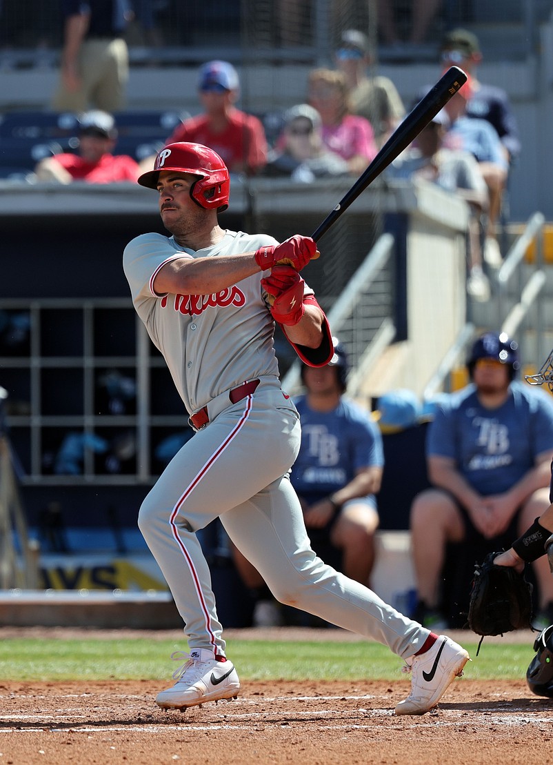 Feb 25, 2025; Port Charlotte, Florida, USA;  Philadelphia Phillies infielder Otto Kemp (82) hits a RBI double against the Tampa Bay Rays during the fourth inning at Charlotte Sports Park. Mandatory Credit: Kim Klement Neitzel-Imagn Images