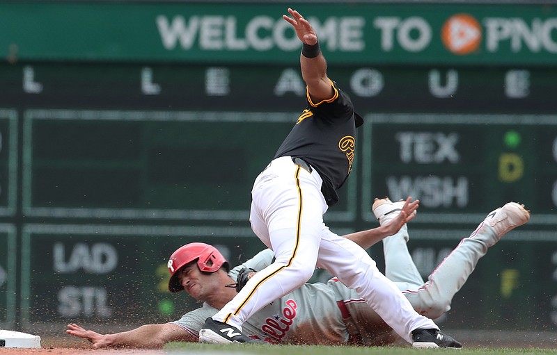 Jun 8, 2025; Pittsburgh, Pennsylvania, USA; Pittsburgh Pirates shortstop Isiah Kiner-Falefa (7) tags Philadelphia Phillies third baseman Otto Kemp (left) out at second base on a steal attempt during the fifth inning at PNC Park. Mandatory Credit: Charles LeClaire-Imagn Images