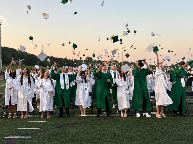 The Pennridge 2025 graduates toss their hats into the air to celebrate their graduation.  (Credit: John Worthington/MediaNews Group)