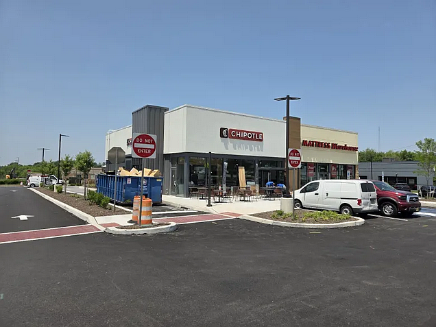 Workers carry equipment into a future Chipotle building on Forty Foot Road in Towamencin on Wednesday, June 4, 2025.