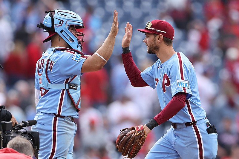 May 29, 2025; Philadelphia, Pennsylvania, USA; Philadelphia Phillies shortstop Trea Turner (7) and catcher Rafael March‡n (13) high five after a victory against the Atlanta Braves at Citizens Bank Park. Mandatory Credit: Bill Streicher-Imagn Images