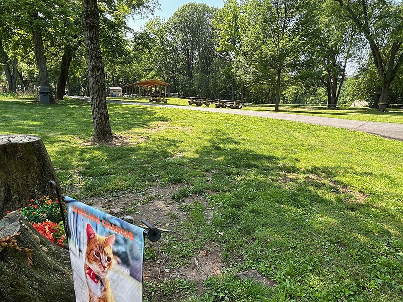 Restroom facilities are seen in the distance from the Charlie memorial in White's Road Park