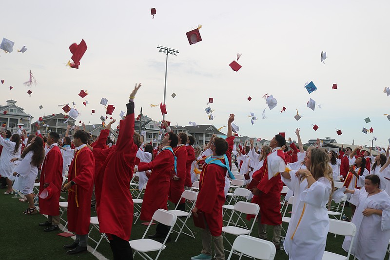 In one final act, the graduates toss their caps into the air in celebration at the end of commencement.