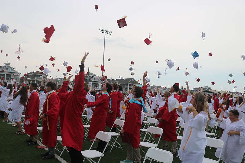 In one final act, the graduates toss their caps into the air in celebration at the end of commencement.