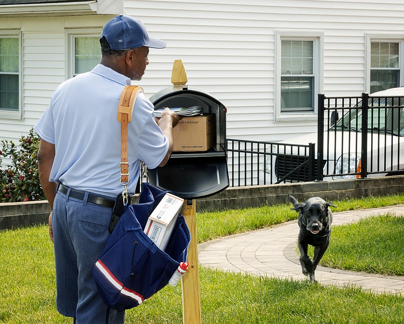 The U.S. Postal Service created staged photos as part of its National Dog Bite Awareness Campaign. The campaign, normally a week long, will extend through June and provide safety tips for mail customers. (Credit: U.S. Postal Service)