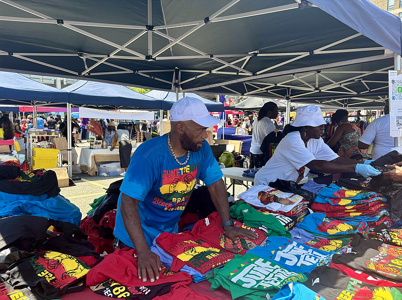Mark Bolt sells shirts he designed for Juneteenth, alongside other Black-owned businesses, vendors and activity booths. (Credit: Kate Jackson)