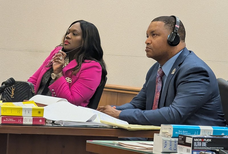 La'Quetta and Marty Small wear headphones to listen in on a sidebar during the suppression motion.