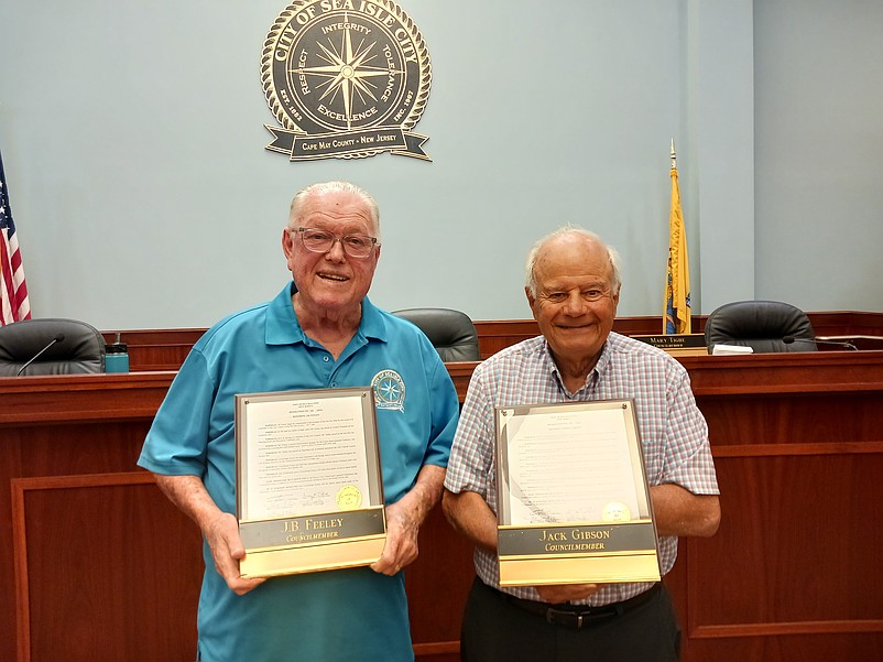 Sea Isle City Councilmen J.B. Feeley, left, and Jack Gibson hold the honorary plaques they were given to thank them for their public service.