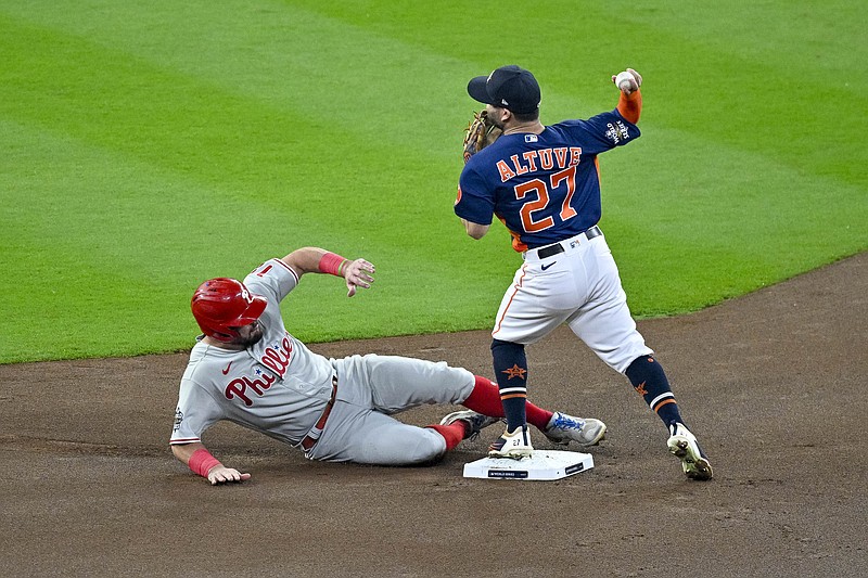 Nov 5, 2022; Houston, Texas, USA; Houston Astros second baseman Jose Altuve (27) puts out Philadelphia Phillies left fielder Kyle Schwarber (12) as he turns a double play against the Philadelphia Phillies during the first inning in game six of the 2022 World Series at Minute Maid Park. Mandatory Credit: Jerome Miron-USA TODAY Sports