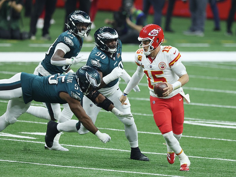 Feb 9, 2025; New Orleans, LA, USA;  Kansas City Chiefs quarterback Patrick Mahomes (15) scrambles away from Philadelphia Eagles defensive end Brandon Graham (55) in the third quarter in Super Bowl LIX at Ceasars Superdome. Mandatory Credit: Stephen Lew-Imagn Images