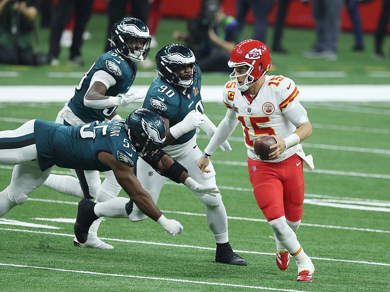Feb 9, 2025; New Orleans, LA, USA;  Kansas City Chiefs quarterback Patrick Mahomes (15) scrambles away from Philadelphia Eagles defensive end Brandon Graham (55) in the third quarter in Super Bowl LIX at Ceasars Superdome. Mandatory Credit: Stephen Lew-Imagn Images