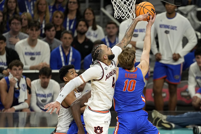 Apr 5, 2025; San Antonio, TX, USA; Auburn Tigers forward Johni Broome (4) blocks the shot of Florida Gators forward Thomas Haugh (10) during the second half in the semifinals of the men's Final Four of the 2025 NCAA Tournament at Alamodome. Mandatory Credit: Scott Wachter-Imagn Images