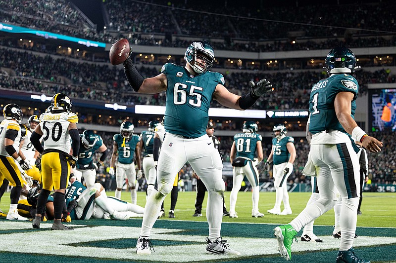 Dec 15, 2024; Philadelphia, Pennsylvania, USA; Philadelphia Eagles offensive tackle Lane Johnson (65) spikes the ball after quarterback Jalen Hurts (1) scores against the Pittsburgh Steelers during the fourth quarter at Lincoln Financial Field. Mandatory Credit: Bill Streicher-Imagn Images