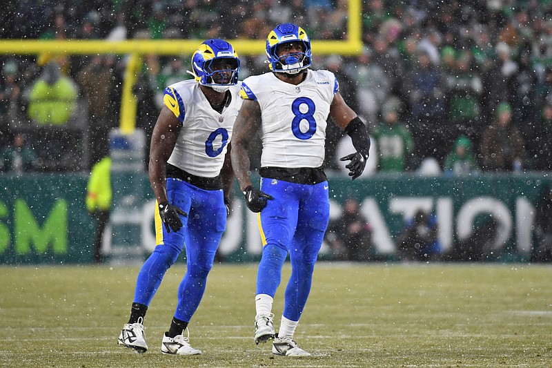 Jan 19, 2025; Philadelphia, Pennsylvania, USA; Los Angeles Rams linebacker Byron Young (0) and linebacker Jared Verse (8) celebrate a sack against the Philadelphia Eagles in a 2025 NFC divisional round game at Lincoln Financial Field. Mandatory Credit: Eric Hartline-Imagn Images