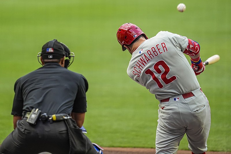 Jun 28, 2025; Cumberland, Georgia, USA; Philadelphia Phillies left fielder Kyle Schwarber (12) hits a double against the Atlanta Braves during the first inning at Truist Park. Mandatory Credit: Dale Zanine-Imagn Images