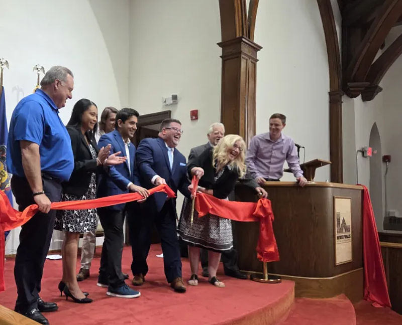 North Wales Mayor Neil McDevitt, center holding scissors, and county commissioners Chairman Neil Makhija cut the ribbon to mark the grand opening of the North Wales Arts and Cultural Center on Monday, June 30, 2025.