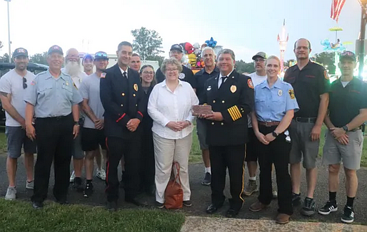 Perkasie mayor Jeff Hollenbach, Perkasie Fire Company personnel and Maureen Purcell pose for a picture.