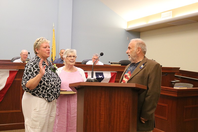 Incumbent Councilwoman Mary Tighe stands next to her mother, Marie Tighe, while taking the oath of office from Mayor Leonard Desiderio.