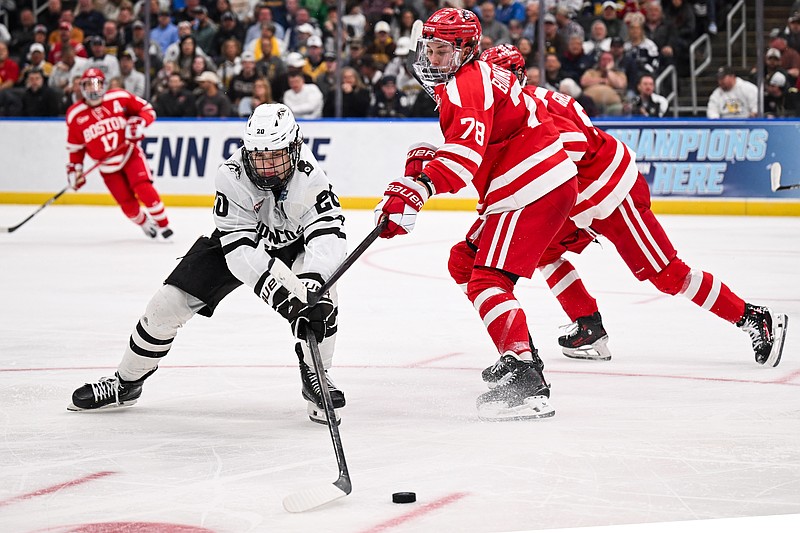 Apr 12, 2025; St. Louis, Missouri, UNITED STATES; Boston University Terriers defenseman Sascha Boumedienne (78) defends against Western Michigan Broncos forward Alex Bump (20) during the second period of the Frozen Four college ice hockey national championship at Enterprise Center. Mandatory Credit: Connor Hamilton-Imagn Images