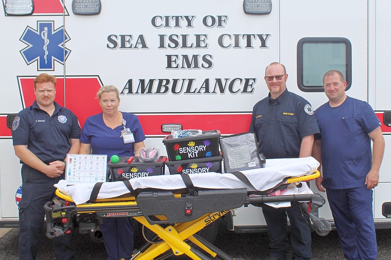 A sensory kit is shown by, from left, Thomas Burns, Sea Isle City EMT, Sherri Richmond, administrative director of Emergency Department, Pediatrics and Respiratory at Shore Medical Center, Sea Isle EMS Chief Bruce Knoll and Michael Smith, clinical development supervisor and pediatric nurse liaison at Shore. (Photo courtesy of Shore Medical Center)