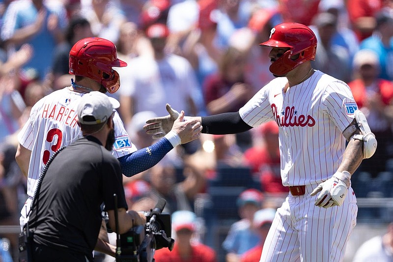 Jul 4, 2025; Philadelphia, Pennsylvania, USA; Philadelphia Phillies outfielder Nick Castellanos (8) high fives first base Bryce Harper (3) after hitting a two RBI home run during the first inning against the Cincinnati Reds at Citizens Bank Park. Mandatory Credit: Bill Streicher-Imagn Images
