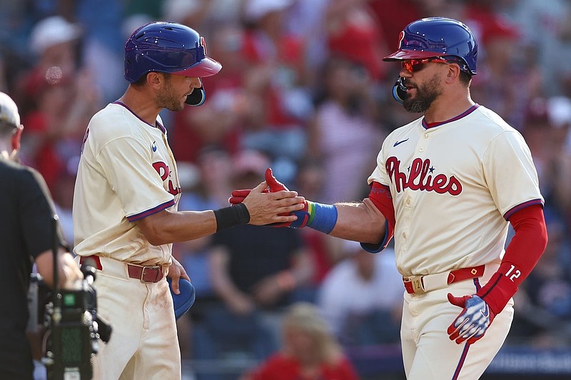 Jul 5, 2025; Philadelphia, Pennsylvania, USA; Philadelphia Phillies outfielder Kyle Schwarber (12) shakes hands with shortstop Trea Turner (7) after hitting a two RBI home run during the eighth inning against the Cincinnati Reds at Citizens Bank Park. Mandatory Credit: Bill Streicher-Imagn Images