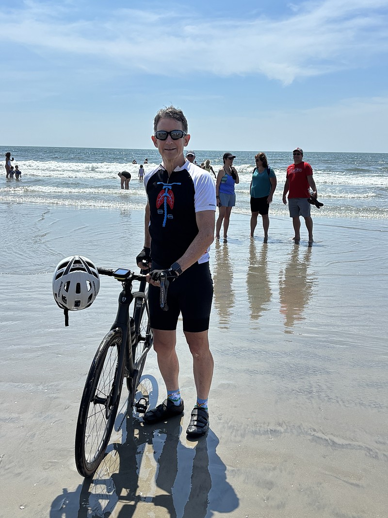 Jack Owens celebrates the end of his cross-country bike journey on the 34th Street beach in Ocean City. (Photo courtesy of John "Jack" Matthews)