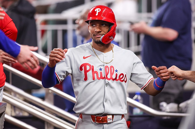 Jun 27, 2025; Atlanta, Georgia, USA; Philadelphia Phillies center fielder Johan Rojas (23) celebrates with teammates after scoring a run against the Atlanta Braves in the ninth inning at Truist Park. Mandatory Credit: Brett Davis-Imagn Images.