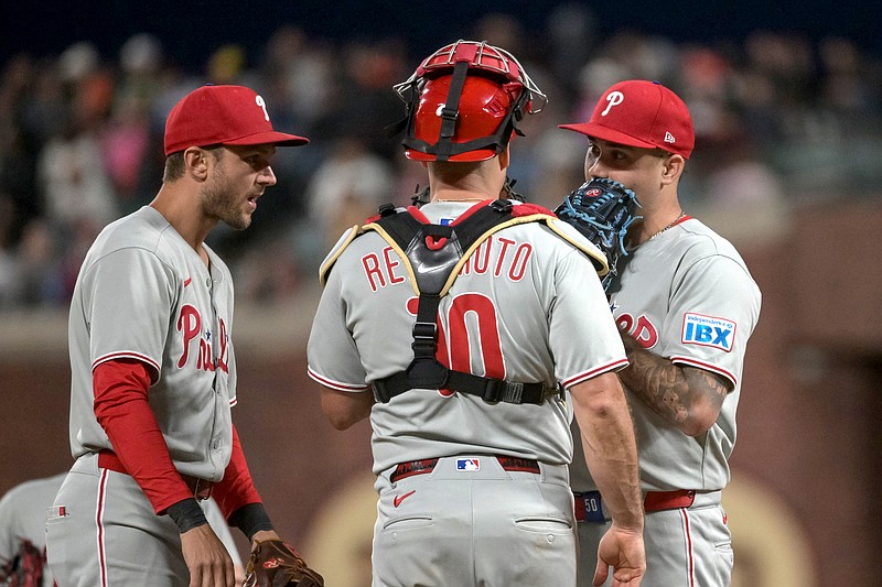 Jul 7, 2025; San Francisco, California, USA; Philadelphia Phillies catcher J.T. Realmuto (10) visits the mound to talk to pitcher Orion Kerkering (50) during the eighth inning at Oracle Park. Mandatory Credit: Ed Szczepanski-Imagn Images