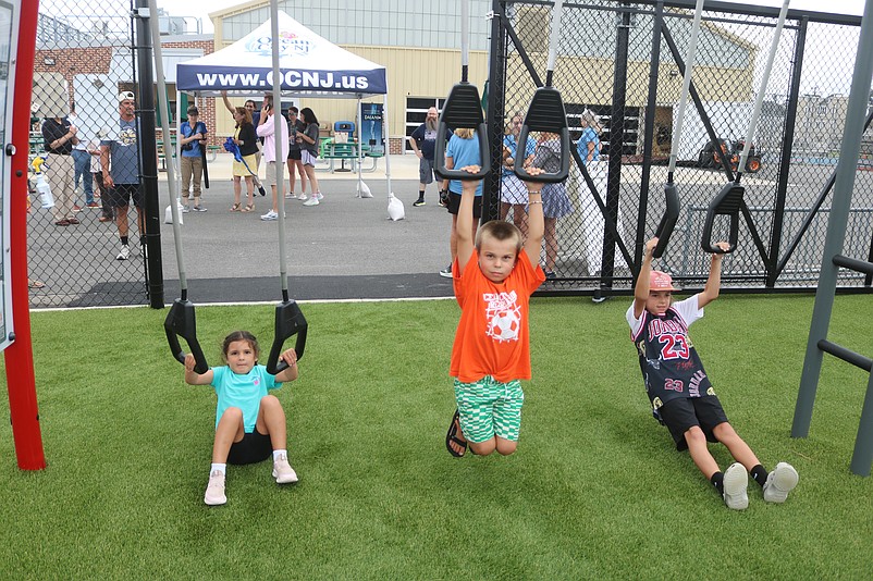 Lena, Luke and Cayden Scioli get a workout on the exercise equipment during the fitness park's grand opening.