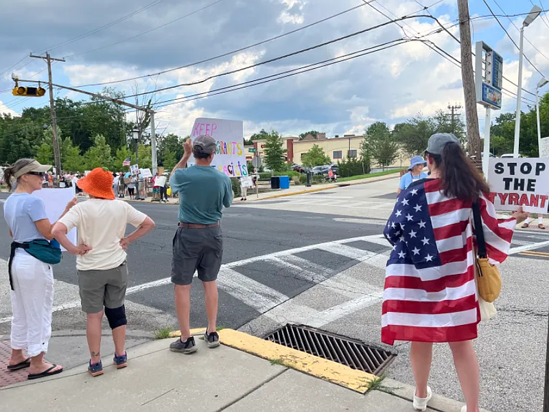 Demonstrators participating in a July 17, 2025 “Good Trouble” protest are pictured holding up signs along Butler Avenue in Ambler. (Rachel Ravina – MediaNews Group)