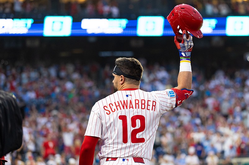 Jul 19, 2025; Philadelphia, Pennsylvania, USA; Philadelphia Phillies outfielder Kyle Schwarber (12) comes out of the dugout for a curtin call after his grand slam during the sixth inning against the Los Angeles Angels at Citizens Bank Park. Mandatory Credit: Bill Streicher-Imagn Images