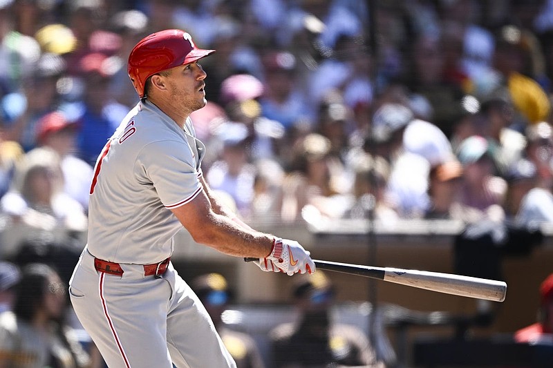 Jul 13, 2025; San Diego, California, USA; Philadelphia Phillies catcher J.T. Realmuto (10) hits an RBI double during the eighth inning against the San Diego Padres at Petco Park. Mandatory Credit: Denis Poroy-Imagn Images