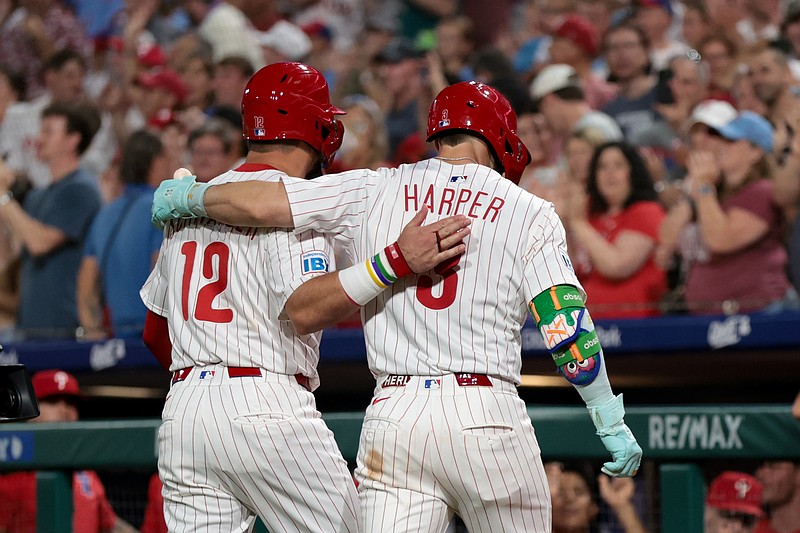 Jul 19, 2025; Philadelphia, Pennsylvania, USA; Philadelphia Phillies first base Bryce Harper (3) walks back to the dugout with his arm around outfielder Kyle Schwarber (12) after his two RBI home run during the eighth inning against the Los Angeles Angels at Citizens Bank Park. Mandatory Credit: Bill Streicher-Imagn Images