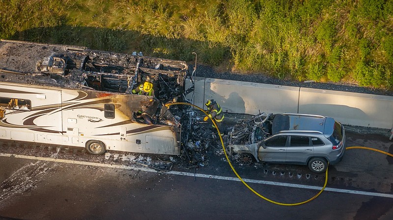 A fire destroyed the rear of an RV, as well as the car it was towing.