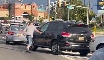 A driver strikes the window of a vehicle in the culmination of a road rage incident captured on video.