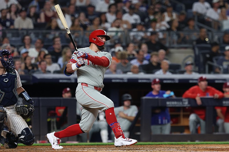 Jul 25, 2025; Bronx, New York, USA; Philadelphia Phillies designated hitter Kyle Schwarber (12) hits a two run home run during the eighth inning against the New York Yankees at Yankee Stadium. Mandatory Credit: Vincent Carchietta-Imagn Images