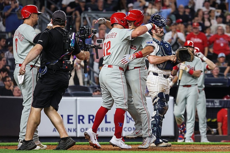 Jul 25, 2025; Bronx, New York, USA; Philadelphia Phillies catcher J.T. Realmuto (10) celebrates with designated hitter Kyle Schwarber (12) and right fielder Nick Castellanos (8) after hitting a three run home run during the seventh inning against the New York Yankees at Yankee Stadium. Mandatory Credit: Vincent Carchietta-Imagn Images