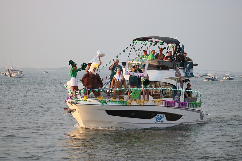A Philadelphia Eagles-themed boat is greeted by chants of "E-A-G-L-E-S" from Night in Venice spectators on shore.