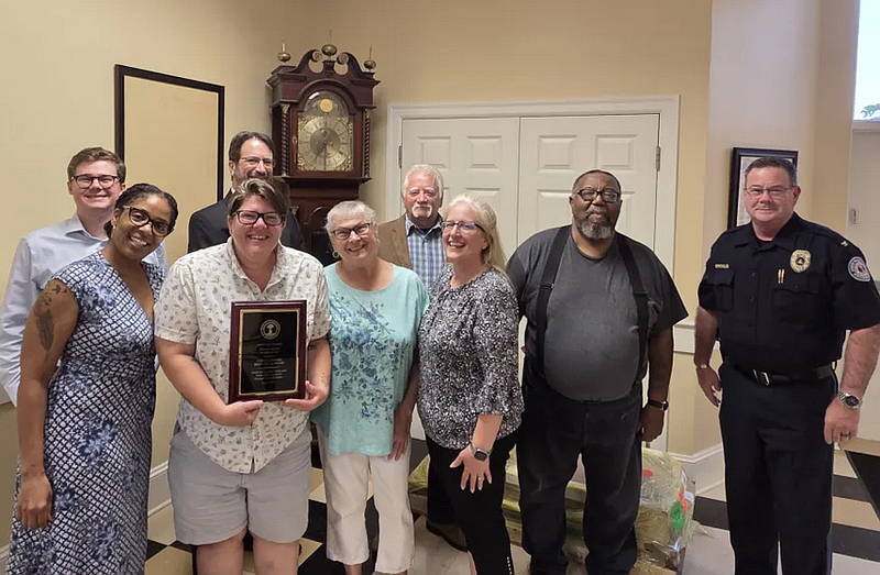 North Wales borough council sends off councilwoman Brittany Kohler, holding plaque, after accepting her resignation during their July 22, 2025 meeting. From left to right in front row are councilwoman Anji Fazio, Kohler, councilwoman Sally Neiderhiser and borough Manager Christine Hart and at rear are councilman Alex Groce, solicitor John Felice, councilmen Sal Amato and Sherwin Collins and police Chief Dave Erenius.