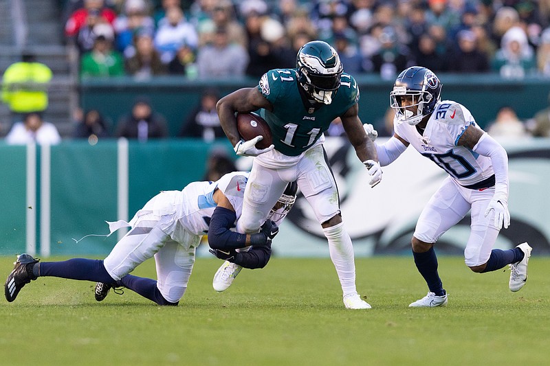 Dec 4, 2022; Philadelphia, Pennsylvania, USA;  Philadelphia Eagles wide receiver A.J. Brown (11) runs the the ball against Tennessee Titans safety Andrew Adams (47) and cornerback Tre Avery (30) after a catch during the fourth quarter at Lincoln Financial Field. Mandatory Credit: Bill Streicher-USA TODAY Sports