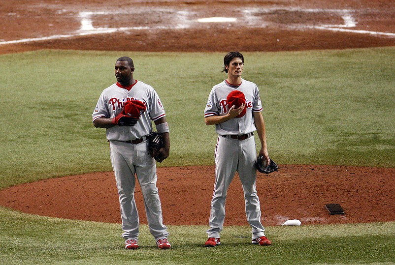 Oct 22, 2008; St. Petersburg, FL, USA; Philadelphia Phillies starting pitcher Cole Hamels (right) and first baseman Ryan Howard stand at the mound during the playing of God Bless America during the seventh inning of game one of the World Series against the Tampa Bay Rays at Tropicana Field. Mandatory Credit: Kim Klement-USA TODAY Sports