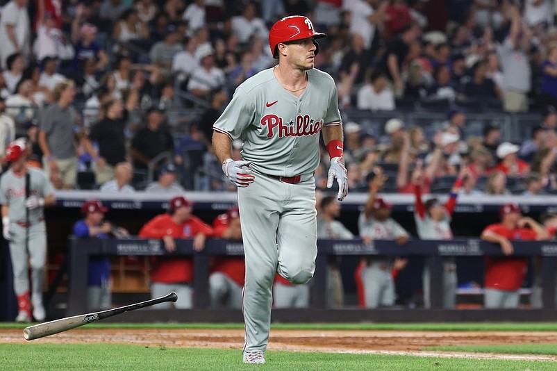 Jul 25, 2025; Bronx, New York, USA; Philadelphia Phillies catcher J.T. Realmuto (10) hits a three run home run during the seventh inning against the New York Yankees at Yankee Stadium. Mandatory Credit: Vincent Carchietta-Imagn Images