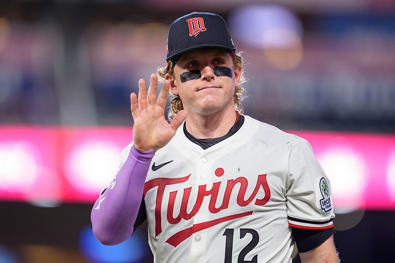 Jul 26, 2025; Minneapolis, Minnesota, USA; Minnesota Twins left fielder Harrison Bader (12) waves at a fan while walking to the dugout after the ninth inning against the Washington Nationals at Target Field. Mandatory Credit: Matt Blewett-Imagn Images